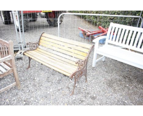 A cast iron and wooden garden bench