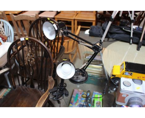 An angle poise style lamp and a clip-on lamp