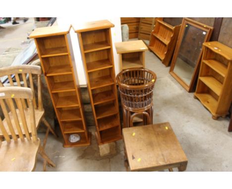 Three narrow shelf units; a wicker plant stand and an occasional table