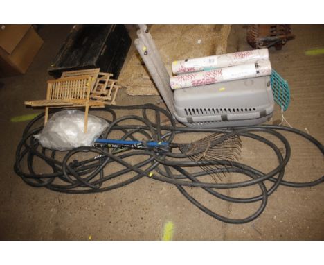 A pet cage; two rolls of wallpaper; a set of cricket stumps; various pipe; garden rack; waking sticks and a sink