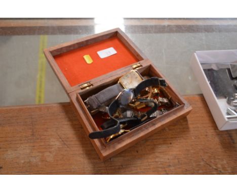 A carved wooden trinket box containing various wrist watches 