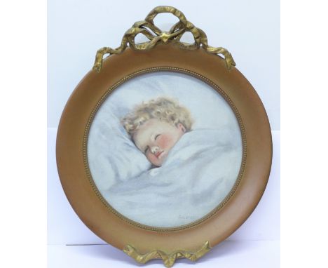 A framed oval print of a sleeping baby, dated 1925