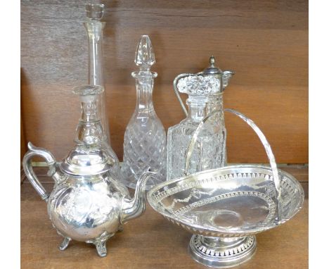 A plated basket and teapot, a claret jug and four glass decanters