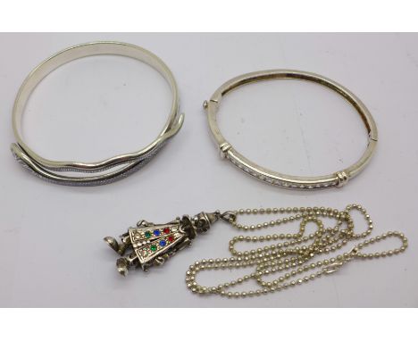 A silver bangle, one other niello snake bangle with Nile scene (tests as silver) and a reticulated clown pendant (tests as si