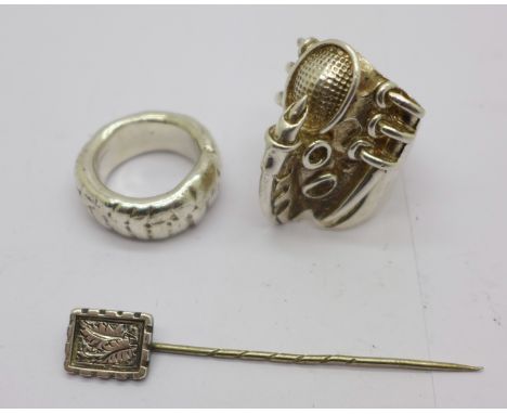 A silver designer ring, a heavy silver ring and a stick pin, (rings 69g)