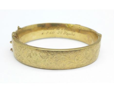 A 9ct gold bangle, bears inscription 24.5g, marked wax filled