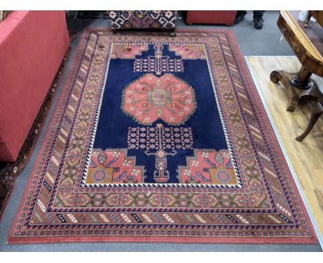 A North West Persian style machined blue ground carpet together with a similar runner, larger 295 x 190cm