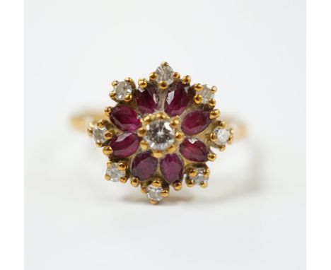 An 18ct, ruby and diamond set flower head cluster ring, size K, gross weight 3.7 grams.