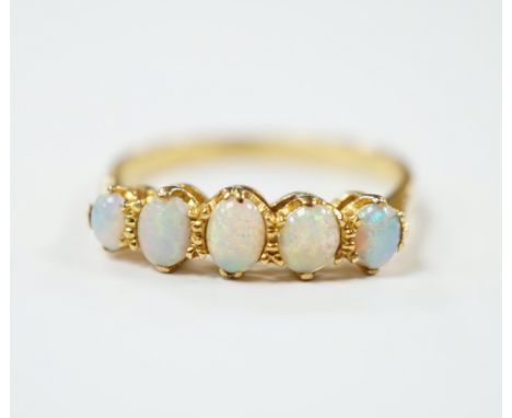 An 18ct and graduated five stone white opal set half hoop ring, size O, gross weight 2.7 grams.