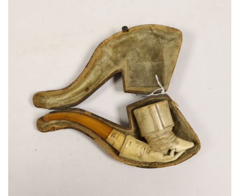 A cased Meerschaum smoker’s pipe in the form a boot and hand The tip of the boot is chipped and there is a atrial fracture to