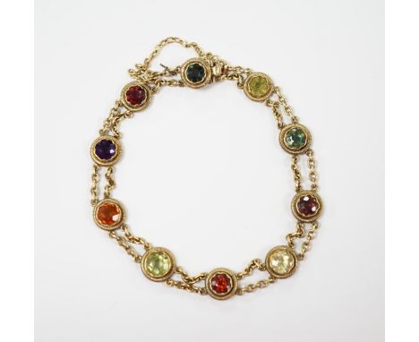 An early 20th century yellow metal (stamped 15 and also 9??) and ten stone multi gem set chain link bracelet, 16cm, gross wei