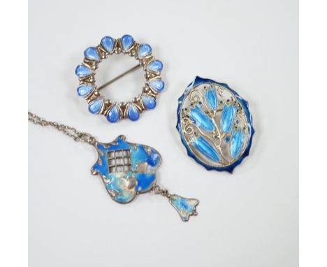 A George V silver and enamel set drop pendant (a.f.), 40mm on a white metal chain and two white metal and enamel brooches, on