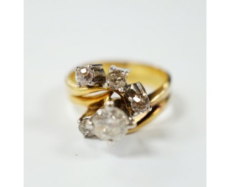 A yellow metal and graduated five stone diamond cluster set dress ring, in a raised setting, size J/K, gross weight 5.5 grams