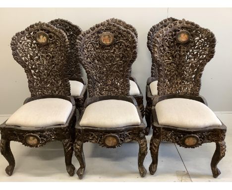 A set of six Indian carved hardwood chairs inset circular portrait plaques, width 48cm, depth 52cm, height 118cm