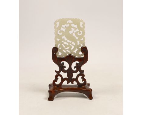 A Chinese jade ‘phoenix’ plaque, late 19th/early 20th century, 5.5 x 4.4cm on hardwood stand,