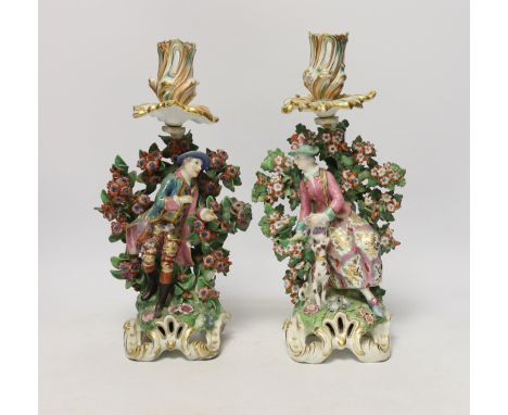 A pair of Chelsea figural candlesticks, c.1765, 30cm Both with numerous damages to bocage, a chip to the bird she holds, the 