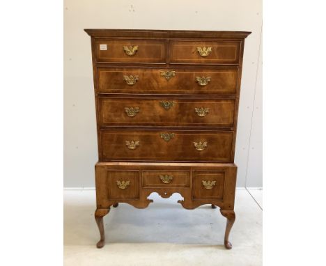 An 18th century walnut chest on stand, width 97cm, depth 56cm, height 146cm Top and sides have horizontal and vertical splits