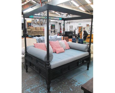 FOUR POSTER BED, Asian, ebonised with spindle, carved panel, tiled decoration and an assortiment of cushions, 207cm H x 198cm