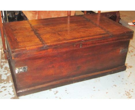 LOW TRUNK, 19th century oak and iron bound with rising lid and carrying handles, 124cm x 70cm x 49cm H.