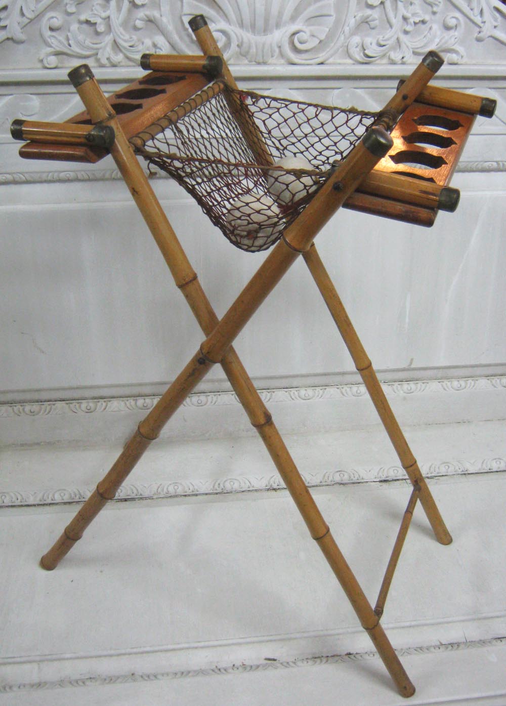 TENNIS RACQUET STAND, circa 1900, with folding bamboo supports, central