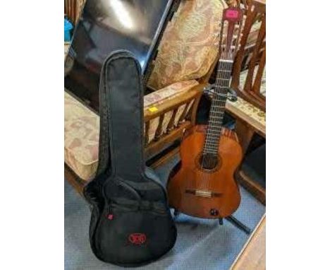 A Yamaha acoustic guitar together with case and standLocation: 