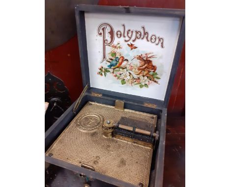 A polyphon music box and 12 discs. Location:1:3 