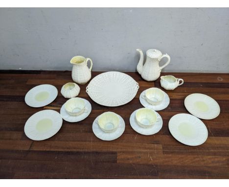 A Belleek cream glazed coffee/tea set of shell design comprising four cups and saucers, a coffee pot, and a tea plate Locatio