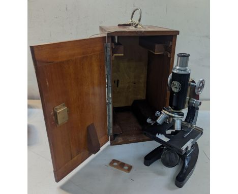 A 1940's C. Baker microscope, having the Broad ordinance arrow and dated Feb 1945 below, in an oak fitted case, with keyLocat