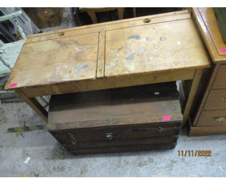 A vintage wooden school desk with two hinged lids to the top container for two ink wells, on square legs, 72cm x 101.5cm x 45