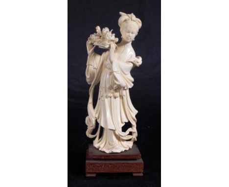 Vintage Chinese carved ivory figure with flowers standing figure on fitted wood base. C:1930. This item may not be exported. 