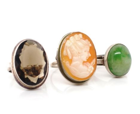 A group of three gem set silver rings includes a carved cameo and quartz examples. Approx ring sizes M, N, Q