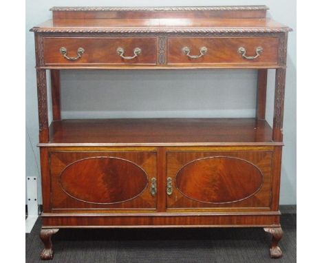 Vintage dumb waiter with mahogany veneer. Two carved drawers over a two door cabinet.