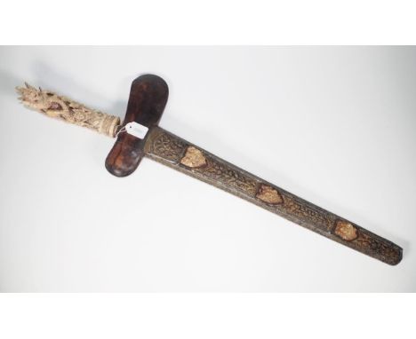 Good vintage Indonesian carved Kris with intricately carved bone handle in form of a deity figure, carved bone and brass shea