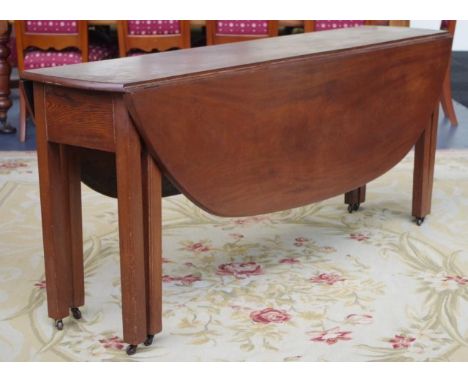 George III Irish mahogany hunt table with D shaped leaves opening to an oval supported by 2 square gate legs, table legs have