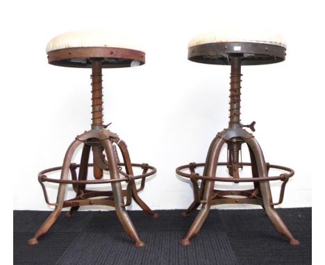 Pair vintage adjustable bar stools each with upholstered seat, and height adjustable metal frame.