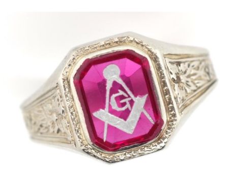 18ct white gold Masonic signet ring with flower decorated shoulders and etched and in filled red synthetic gemstone. Rubbed g