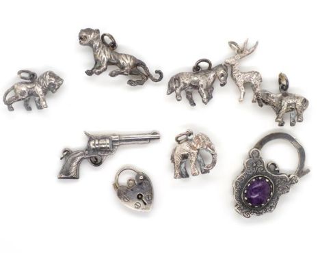 A group of silver charms and clasps includes cast , figures of a  lion, donkey, tiger and revolver. As well as a amethyst set