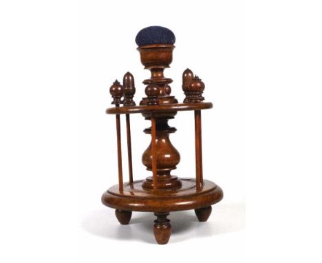 Victorian Oak sewing caddy with 6 reel spindles with turned tops, 2 thimble holders in the shape of acorns, 3 turned feet and
