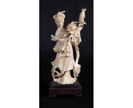 Vintage Chinese carved ivory figure standing woman with flowers, on fitted wood base. C:1930. This item may not be exported. 