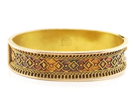Victorian gold bangle with a recessed band and applied bead and filigree decoration. Marked pat'd feb 25 1879. With push butt