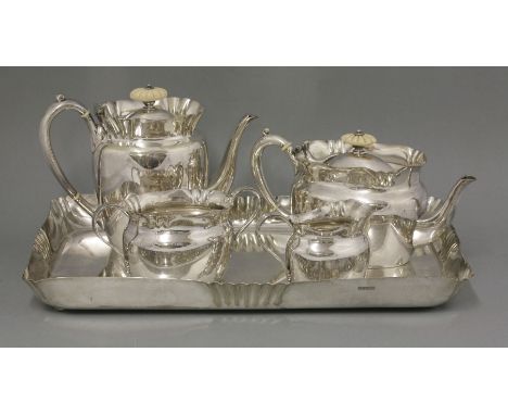 A silver-plated four-piece teaset,by Hukin and Heath, stamped 'RN No 94009', on a matching tray (5)