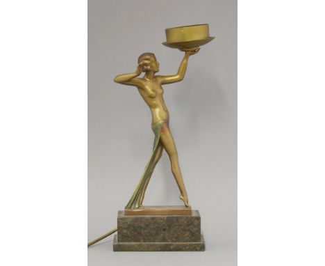 An Art Deco spelter table lamp,modelled as a light, globe shade missing, on a marble plinth,40.5cm high