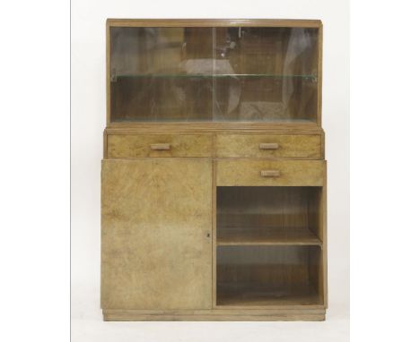 An Art Deco walnut cabinet, with a sliding glass front over three drawers, a cupboard and a shelf,92.5cm wide36cm deep123.5cm