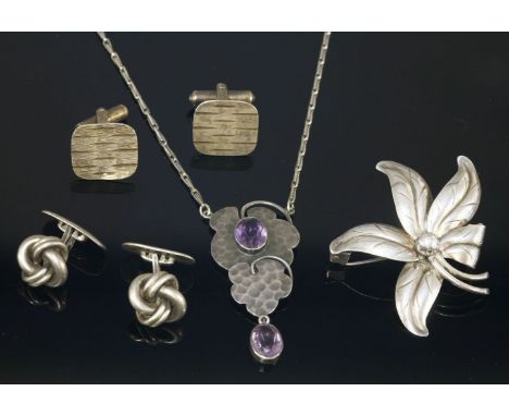 A Jugendstil amethyst and paste necklace,with a centrepiece composed of hammered cloud shapes, rub set with an oval purple pa