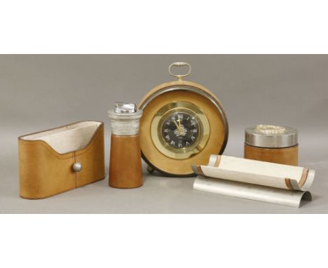 A set of tan leather-mounted desk items,after Jacques Adnet, a Jaeger-LeCoultre clock, a table lighter, a jar and cover, a le