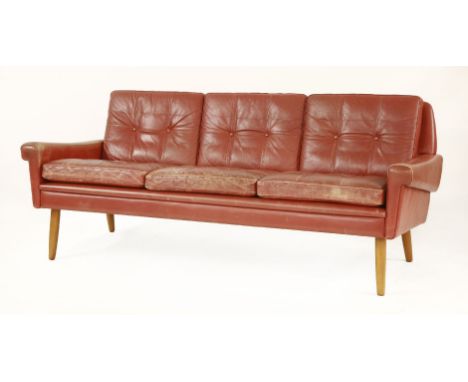 A Danish red leather settee,by Skippers Møbler, on light beechwood turned legs,182cm wide