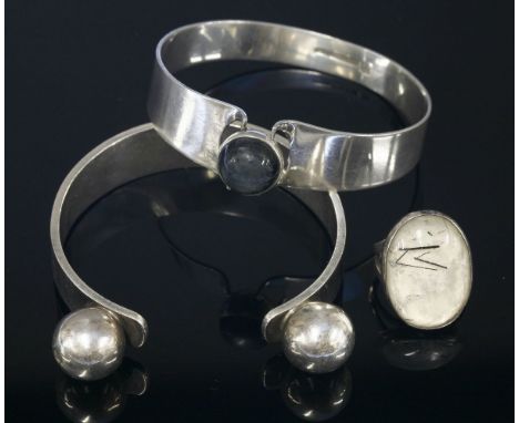 A Finnish sterling silver labradorite bangle,by Kaunis Koru, Helsinki, a circular cabochon labradorite, rub set to a dome bac