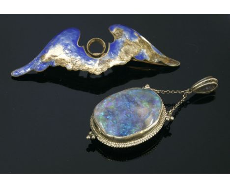 An Arts and Crafts black opal pendant,with an oval black opal matrix cabochon, rub set to a plain frame, two twisted wire dec