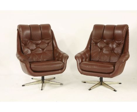 A pair of brown leather armchairs,with button backs and seats on chrome swivel stands (2)