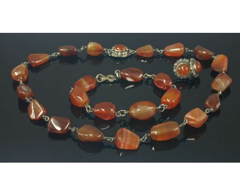 An Arts and Crafts silver and cornelian matched necklace, bracelet and earring suite,the necklace attributed to Dorrie Nossit